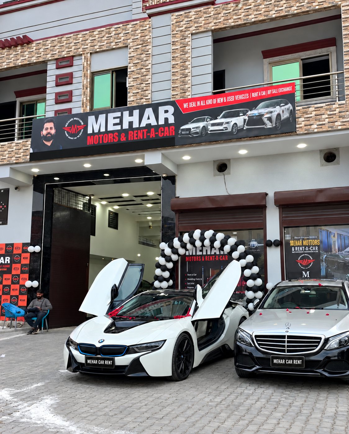 Mehar Motors Gujranwala showroom with a white BMW i8 and Mercedes outside